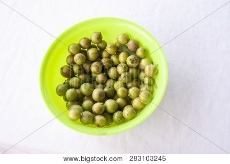 Bowl Of Mamoncillo Fruit On A White Table Cloth In Colombia, South America