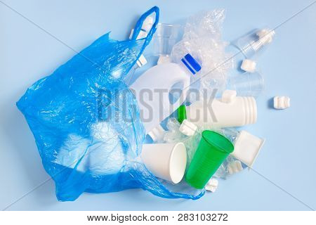 Various Plastic Garbage On The Light Blue Background, Problem Of Waste Sorting And Utilisation