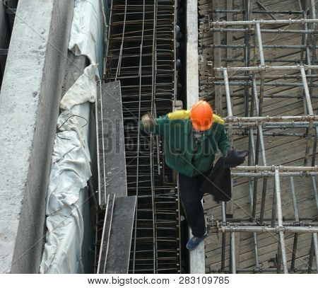 Image Of One Workpeople Balance On Ledge At Day