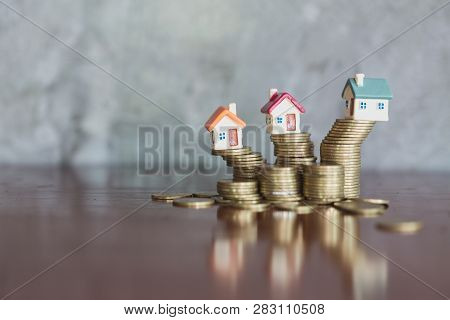 Mini House On Stack Of Coins,money And House,  Mortgage, Savings Money For Buy House And Loan To Bus