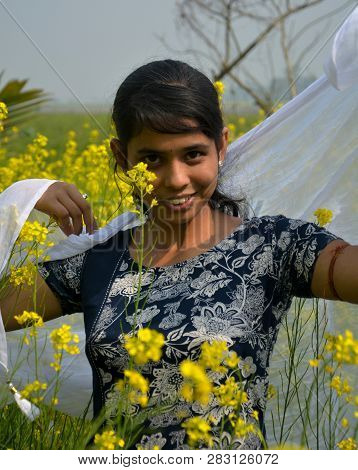 Close Up Of A Laughing Girl Wearing A Blue Salwar And Covering Her Dead With A White Cloth In  Rapes