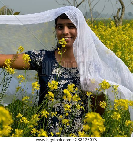 Close Up Of A Laughing Girl Wearing A Blue Salwar And Covering Her Dead With A White Cloth In  Rapes