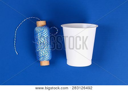 Diy Pencil Holder Plastic Glass Sour Cream, Yogurt Wrapped Thread Blue Background. Decoration Flower