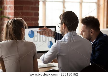 Rear View At Business Analysts Employees Talking Discussing Work Results