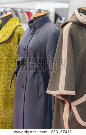 Womens Coat In The Store. Spring Womens Coats Hanging On A Rack In A Womens Clothing Store. Ertical 