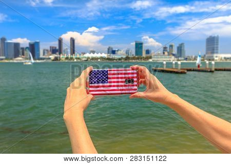 Tourism And Travel In California, West Coast. Mobile Phone With American Flag Cover Taking Photos Of