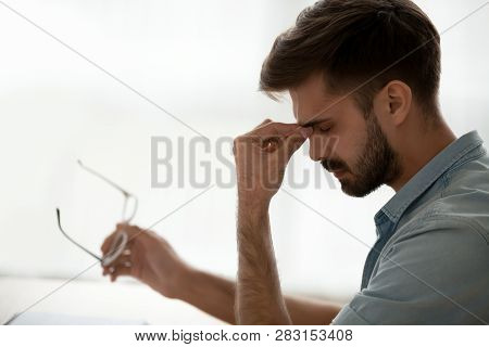Tired Stressed Guy Taking Off Glasses Feeling Eyestrain Or Headache