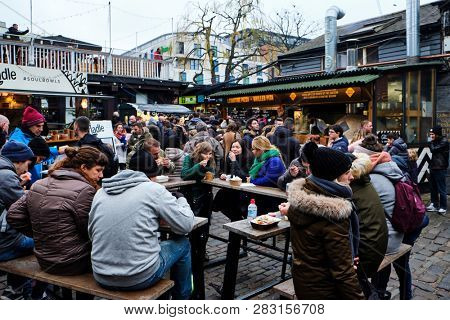 LONDON, UK - DECEMBER 30, 2018: Visitors at Camden Lock. Camden Lock, Camden Market, and streets nearby are the fourth-most popular attraction in the city, attracting 100,000 people each weekend