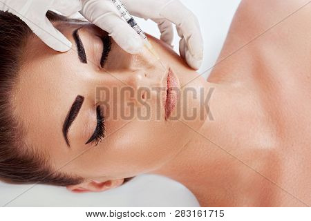 Beautiful Young Female Face And Hands In Gloves With Beauty Treatment Injection Isolated On White. F