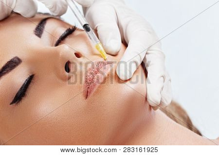 Beautiful Woman Getting Cosmetic Injection  In Lips, Plastic Surgery, Beauty Concept. Closeup Hand I