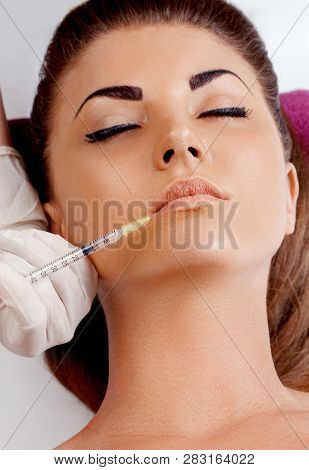Beautiful Woman Getting Cosmetic Injection Of Botox In Lips, Plastic Surgery, Beauty Concept. Closeu