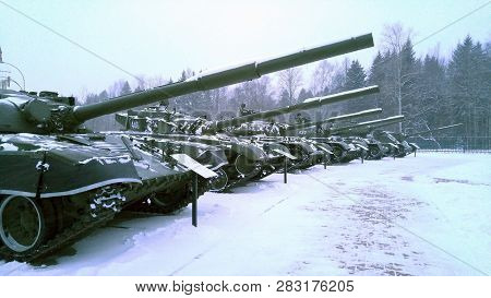 T 34 Battle Tanks Stand In A Row. Winter Snowfall. Soviet Medium Tank T-34 Of The World War Ii