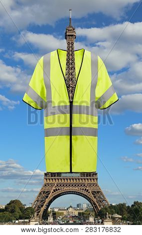 Very Big Jacket Symbol Of Yellow Vests Movement On Eiffel Tower In Paris France. This Is A Photomont