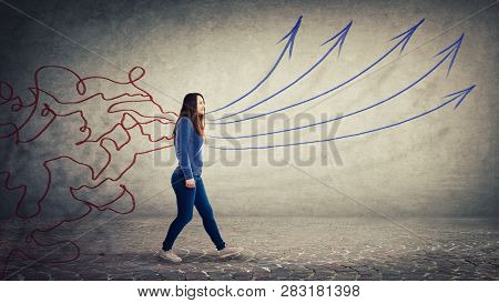 Concept Of Information Processing As A Concentrated Woman Walking Over Grey Wall Background As Mess 