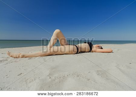 Beautiful Young Woman In Swimsuit At Sand Sea Beach Looking At Camera, Toned Image