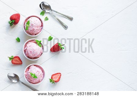 Strawberry Ice Cream And Fresh Strawberries On White Background, Top View. Three Bowls Of Strawberry