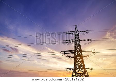 High Voltage Post Or High Voltage Tower On Sunset Background.