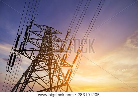 High Voltage Post Or High Voltage Tower On Sunset Background.