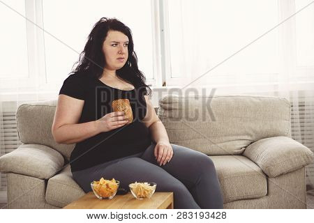 Lack Of Physical Activity, Imbalanced Nutrition, Laziness, Homebody. Lonely Fat Woman Watching Serie
