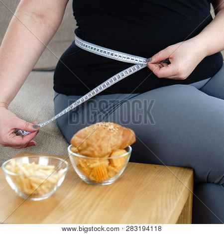 Stress, Eating Problems, Compulsive Overeating, Weight Gain. Overweight Woman With Measuring Tape On