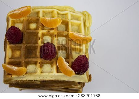 Waffle Put On Background, Isolate, Delicious Waffle. Waffles With Raspberries And Tangerine Slices. 