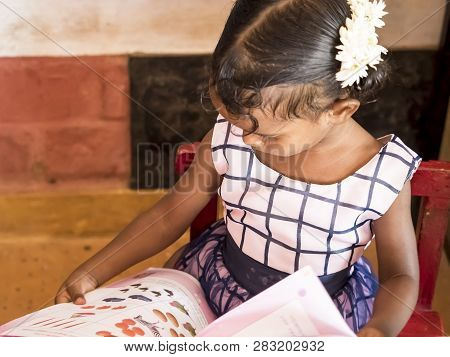 Puduchery, India - December Circa, 2018. Unidentified Cute Beautiful Poor Concentrated Kid Reading A