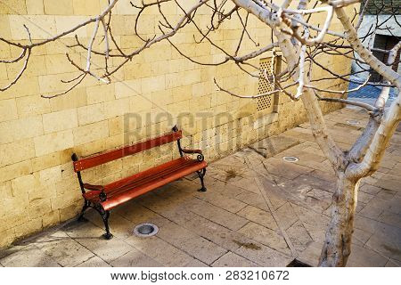 Brown Wooden Bench In The City Park.