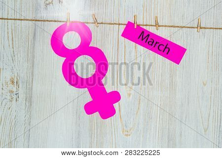 Womens Day Concept. The Symbol Of Venus, The Feminine. Pined On The Clothespins Paper Figure Eight A