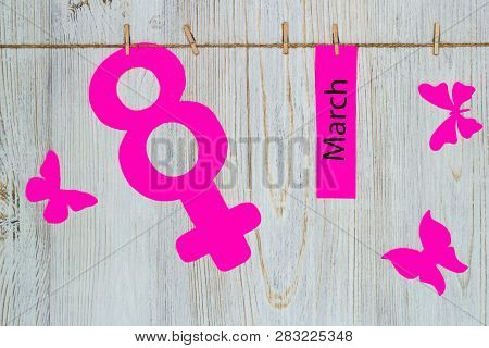 Womens Day Concept. The Symbol Of Venus, The Feminine. Pined On The Clothespins Paper Figure Eight A
