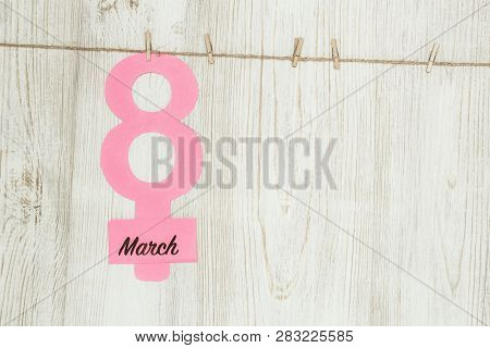 Womens Day Concept. The Symbol Of Venus, The Feminine. Pined On The Clothespins Paper Figure Eight A