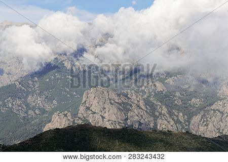 Mountains With Clouds In Central Corsica, France.