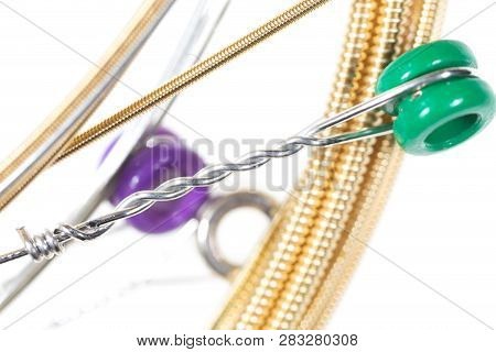 Strings For Guitar Isolated On A White Background. Macro