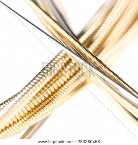 Strings For Guitar Isolated On A White Background. Macro