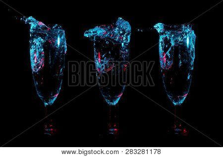 Splashes And Bubbles Of Clear Liquid Lit In Blue Lights With Red Accent Lights In A Row Of Three Ide