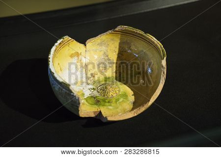 Broken Clay Plate Lying On A Black Backround . Old Vintage Style