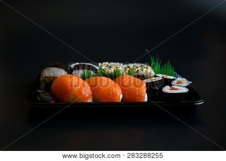 Close Up Top View Mix Sushi With Various Ingrediant As Salmon, Tuna, Avocado,sesame On Black Backgro