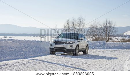 White Range Rover Evoque With A Black Roof On A Winter Road On The Background Of Zhiguli Mountains O
