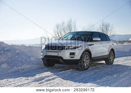 White Range Rover Evoque With A Black Roof On A Winter Road On The Background Of Zhiguli Mountains O