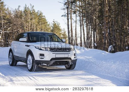 White Range Rover Evoque With A Black Roof On A Winter Road In The Forest Of The Samara Region, Russ