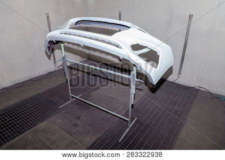 Repair Of The Rear Bumper Of A White Car After An Accident With The Help Of Multi-colored Putty In A