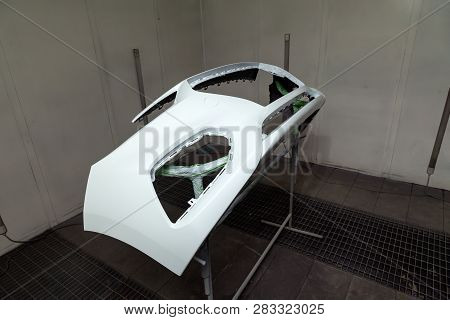 Repair Of The Rear Bumper Of A White Car After An Accident With The Help Of Multi-colored Putty In A