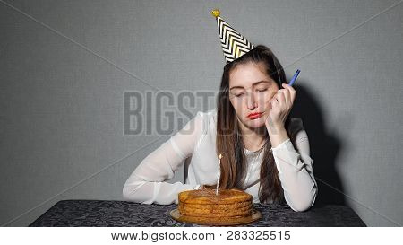 Sad Lonely Woman In Party Hat Celebrating Birthday Alone, Close Up