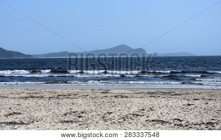 View Onto The Coast Near Seal Rocks On A Sunny Day. The Little Island At The Southern End Of Number 