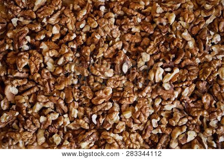 Background Of Peeled Walnuts On A Wooden Surface. Edible Texture. Rustic Still Life.