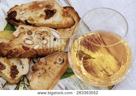 Biscotti Cookies With Sweet Wine Vin Santo On Wooden Desk. Cup Of Wine, Sweet Wine And Dessert Bisco