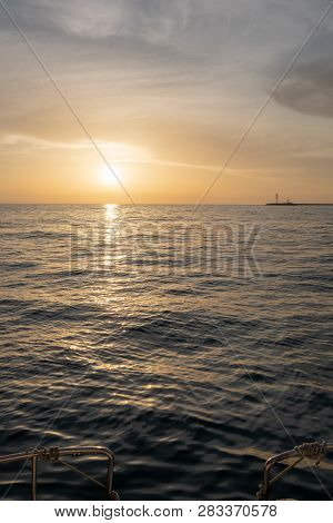 Waves And Foam Astern Of The Yacht. The Setting Sun Is Beautifully Reflected In The Water. Backgroun