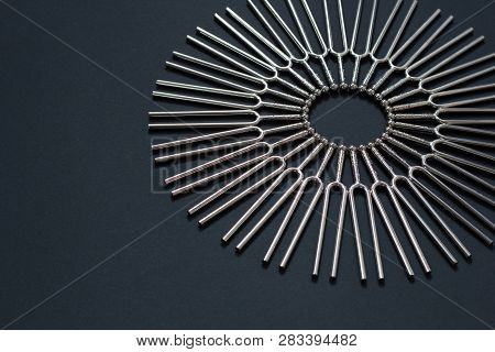 Tuning Fork Round Pattern On A Black Background