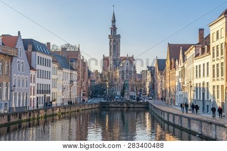 Brugge, West Flanders  Belgium - December 2018: Spiegelrei Canal, Jan Van Eyck Square And Poorterslo