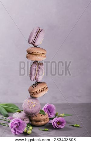 Sweet French Macarons Cookies Stacked On Grey Background. Pastel Colored Balansed Macaroons. Food, C