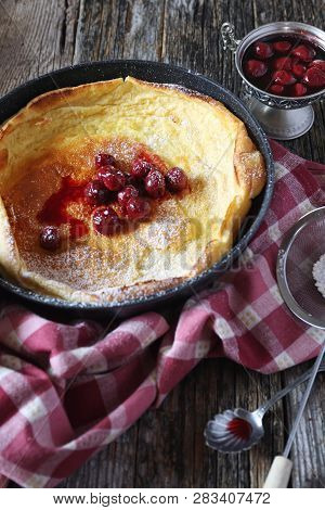American Cuisine: Duth Beby Lush Omelet In Frying Pan, Powdered Sugar And Cherry Jam Dressing